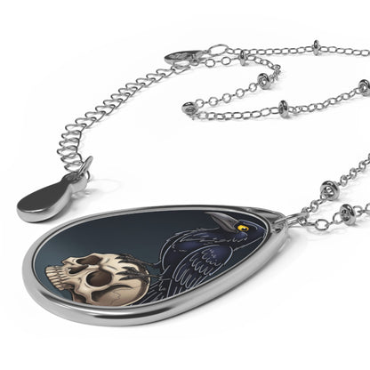 Teardrop-shaped pendant with skull design on a white background